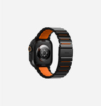 UNIQ Strova Flex stainless steel Apple Watch strap Midnight Black Volt Orange - worn on wrist